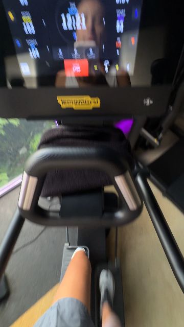 A woman works out on a rowing machine in a gym.